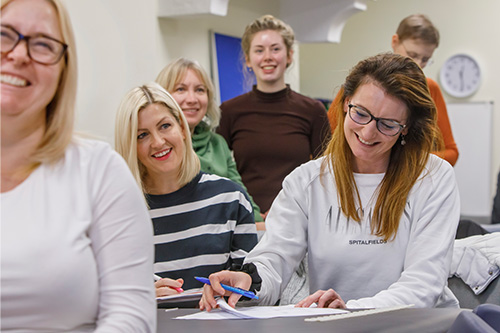 female acupuncture students smiling in a classroom