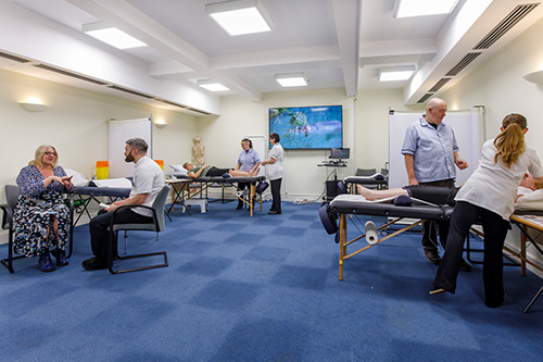 students, teachers and clients in teaching acupuncture clinic