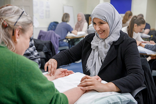 female acupuncturist treating a client in a training clinic