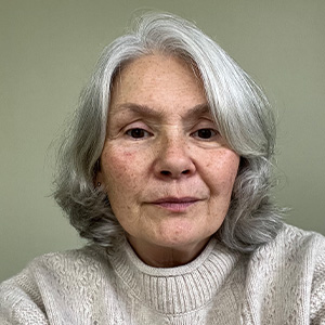 smiling woman with light hair and light jumper