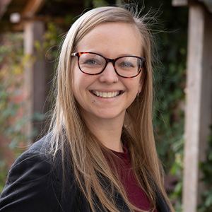 smiling woman with glasses and blonde hair