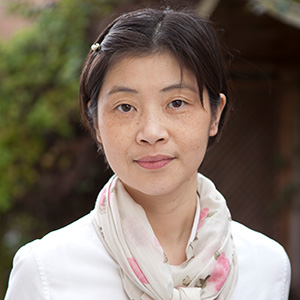 Chinese woman in a white shirt and scarf