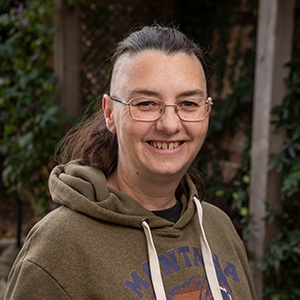 woman wearing glasses and smiling in the garden